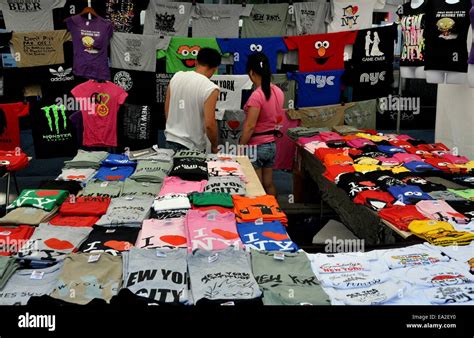 Nyc Couple Shopping For Clothing In A Vendors Tee Shirt Booth At A