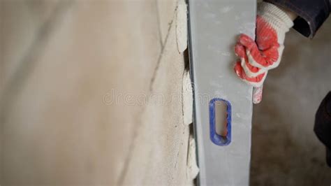 A Builder Measures The Level With A Laser Beam On An Indoor