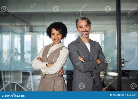 Two Diverse Man And Woman Business Team Stand In Office Arms Crossed