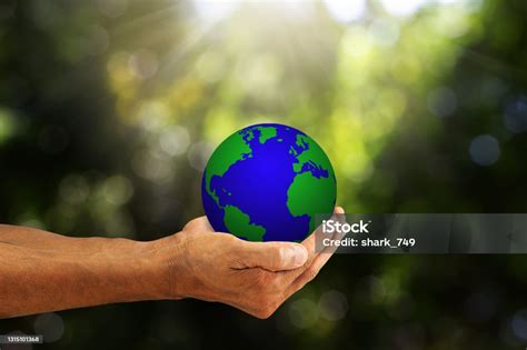 Hands Holding Planet Earth On Blurred Green Nature With Sunlight Background Environmental