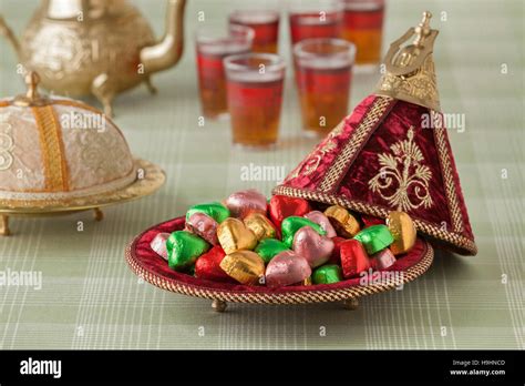 Moroccan Festive Sweets In A Red Tajine And Tea Stock Photo Alamy