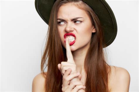 Premium Photo Woman In A Green Hat Finger Near Mouth Open Lips