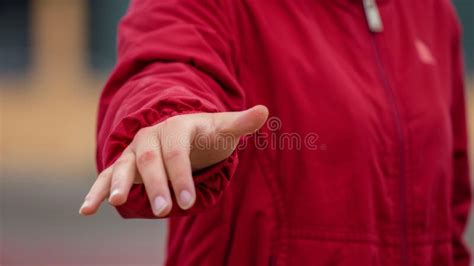 A Woman In Red Jacket Holding Out Her Hand To The Side Ai Stock Image