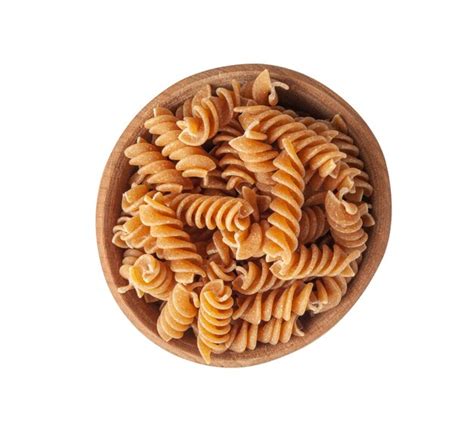 Premium Photo Raw Brown Pasta Isolated Wholegrain Fusilli Pile In