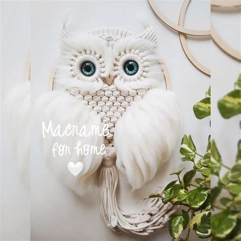 An Owl Made Out Of Yarn With Blue Eyes Sitting On Top Of A White Table