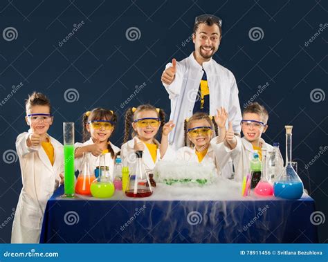 Happy Kids With Scientist Doing Science Experiments In The Laboratory