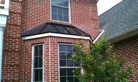 Installing Custom Shaped Matte Black Standing Seam Metal Roof Over Bay