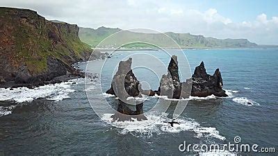 Pointy Rocks Sticking Out Of The Ocean At Reynisfjara Beach Near Vik In