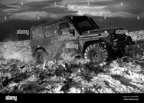 Front View Of Massive 4x4 Off Road Car On The Dirty Snowed Ground