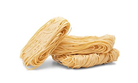 Premium Photo Dry Strips Of Egg Noodles Pasta Nests Isolated On