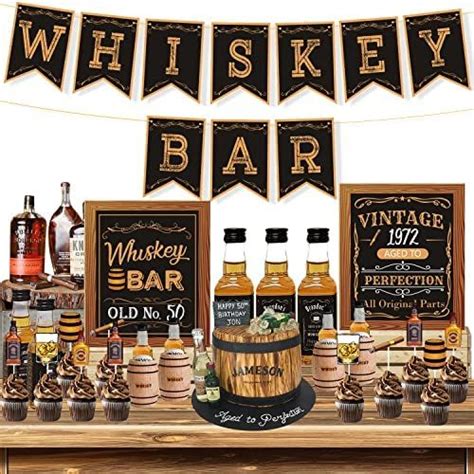 A Table Topped With Bottles Of Whiskey And Cupcakes Next To A Sign That