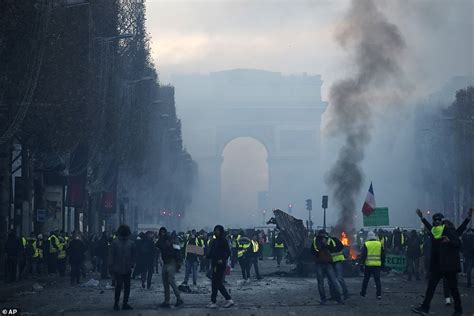 Paris Riot Police Clash With Protesters Demonstrating Over Fuel Tax