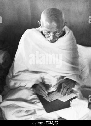 Mahatma Gandhi Writing An Address On An Envelope In His Hut At Stock