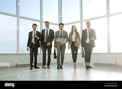 Business People Walking In The Office Corridor Stock Photo Alamy