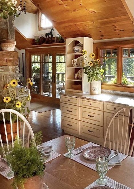 A Kitchen And Dining Room Area With Wood Flooring White Chairs And