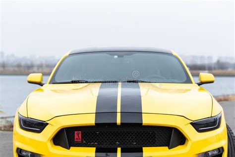 Yellow With Black Stripes Ford Mustang Muscle Car In A Parking Lot