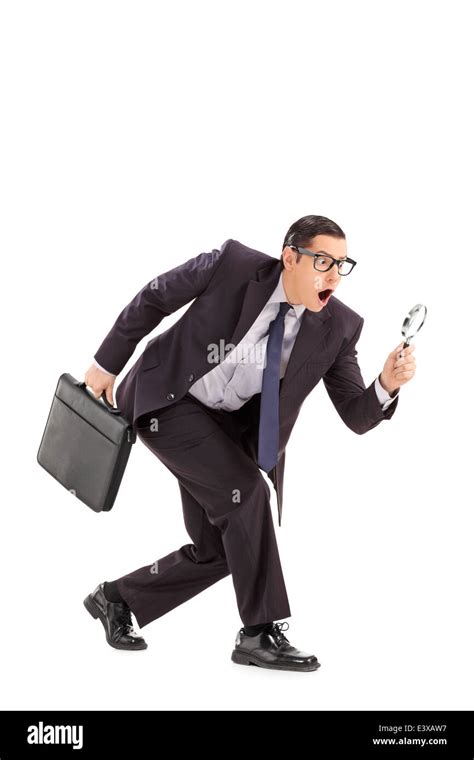 Sneaky Businessman Looking Through A Magnifying Glass Stock Photo Alamy