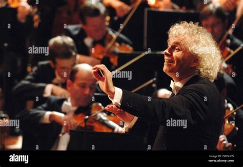 Sir Simon Rattle conducts the Berlin Philharmonic Stock Photo - Alamy