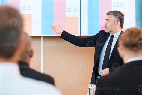 Talking About Numbers Confident Mature Man In Formalwear Pointing