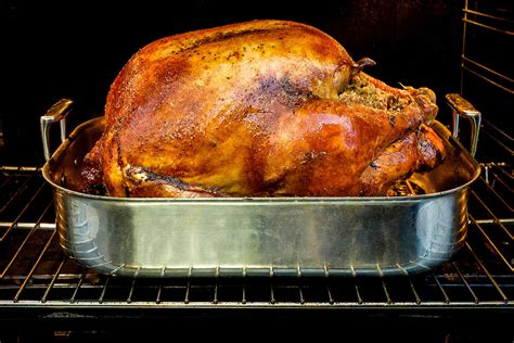 Seasoned Whole Christmas Turkey With Stuffing Forks And Fingers