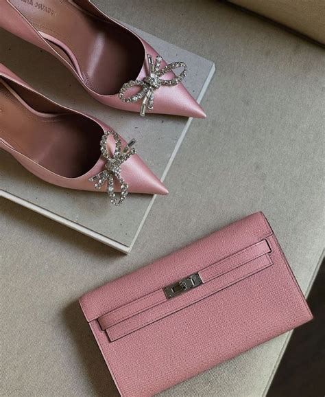 Two Pairs Of Shoes And A Pink Purse On A Table