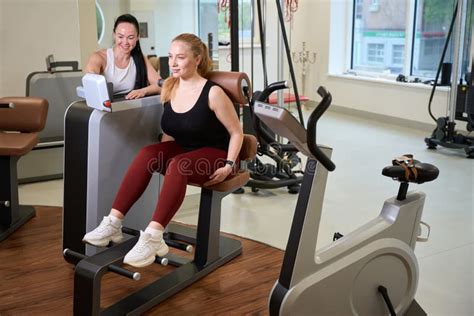 Female Fitness Trainer Examines The Performance Of The Client Stock Image Image Of Brunette
