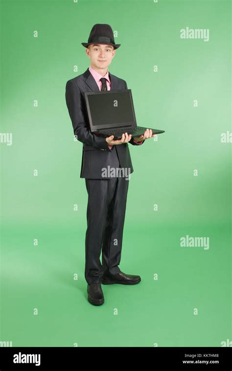 Full Length Portrait Of Confident Mature Businessman With A Laptop In