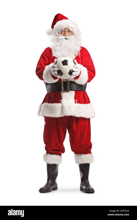 Full Length Portrait Of Santa Claus Standing And Holding A Football