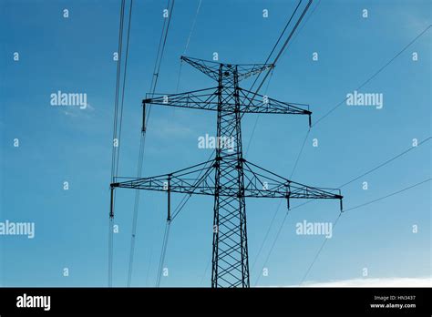 High Voltage Pylon On Skies Background Transmission Line Tower In