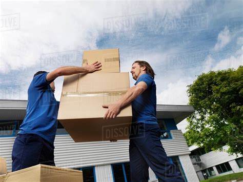 Two Men Carrying Boxes Stock Photo Dissolve