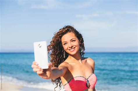 Beautiful Woman Taking Selfie On The Beach By Stocksy Contributor