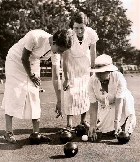 three women are playing with bowling balls in an old black and white ...