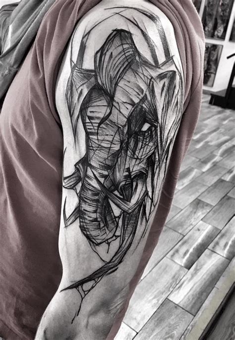 Creepy looking black ink upper arm tattoo of elephant by Inez Janiak - Tattooimages.biz