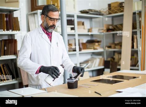 View At Handsome Mature Engineer In The Laboratory Examines Ceramic