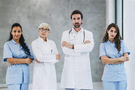 Team Of Doctors And Nurses Standing With Arms Crossed And Looks At