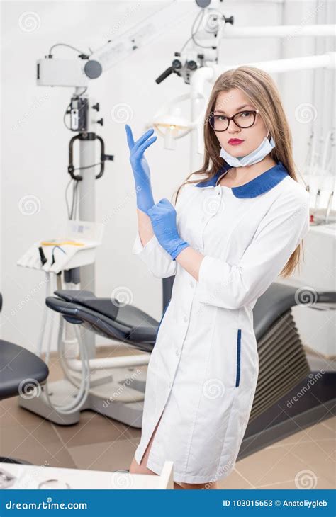 Portrait Of Young Attractive Female Dentist Holding Dental Tool At The