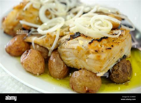 Typical Portuguese Dish Bacalhau A Lagareiro Cod Fish With Olive Stock