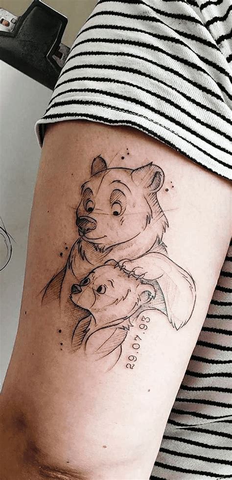 a woman with a bear tattoo on her arm and leg, holding onto another bear