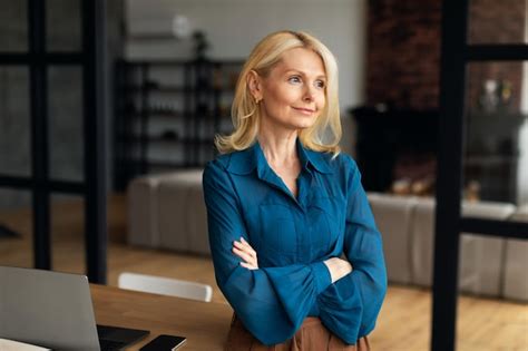 Premium Photo Stylish Mature Woman Posing At Workplace At Home