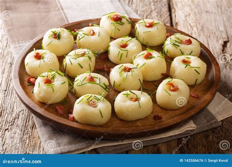 Boiled Potato Dumplings With Fried Bacon And Fresh Green Onions Close