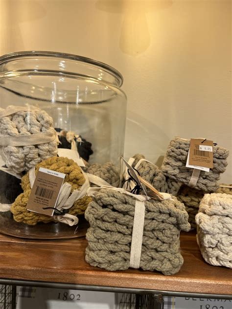 Several Crocheted Baskets On A Table With Tags Attached To The Handles