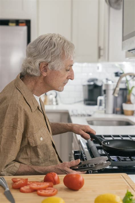 Old Man Cooking At Kitchen · Free Stock Photo