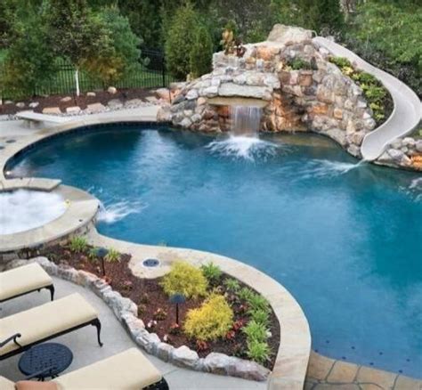 Stone Pool With Slide Diving Board And Hot Tub Pools Backyard