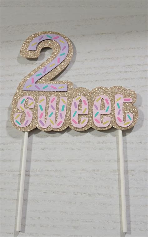 Two Sweet Birthday Cake Topper On A Stick With Sprinkles And The Number 2