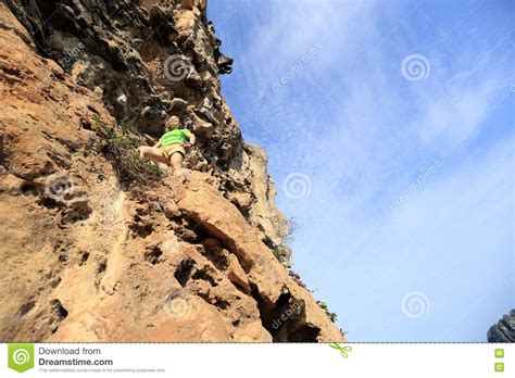 Woman Rock Climber Climbing At Seaside Mountain Cliff Stock Image