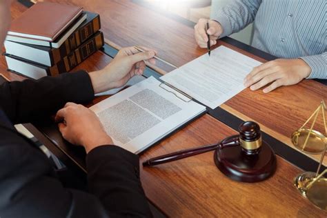 Premium Photo Midsection Of Businessman Signing Document With Judge