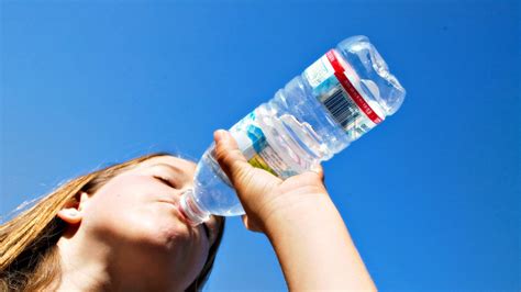 Download Woman Drinking Water From Bottle Wallpaper