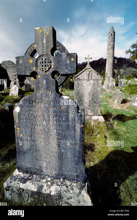 Glendalough, monastery ruins, old gravestone with celtic cross, round ...