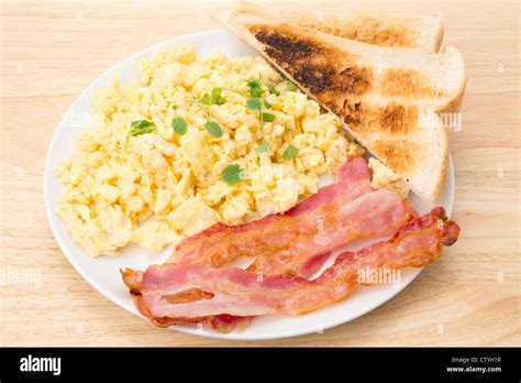 Breakfast Of Scrambled Eggs With Streaky Bacon And Slices Of Toasted