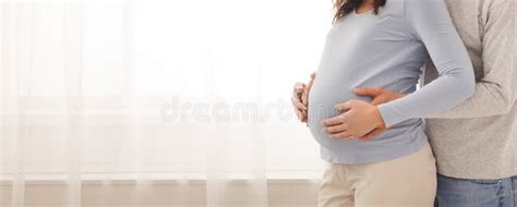 Loving Man Tenderly Cuddling His Wife`s Belly From Behind Stock Image